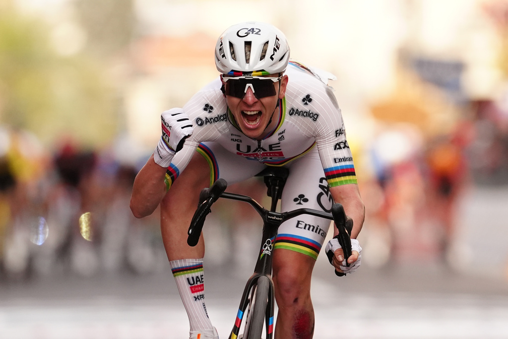 Slovenia's Tadej Pogacar of UAE Team Emirates XRG celebrates after crossing the finish line ahead of Britain's Thomas Pidcock of Pinarello-Q36.5 Pro Cycling Team to win the men's elite race of the Milano-Sanremo one day cycling race (298 km) from Pavia to Sanremo, Italy, March 21, 2026. (Massimi Paolone/LaPresse via AP)