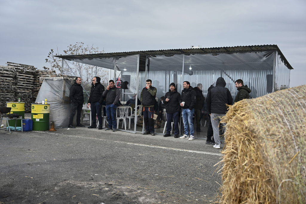 Farmers and supporters block a highway at the Malgara toll stations near Thessaloniki, northern Greece, on Wednesday, Dec. 3, 2025, during a protest over delays in farm subsidy payments. (AP Photo/Giannis Papanikos)