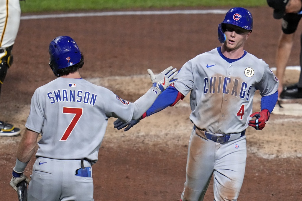 Chicago Cubs' Pete Crow-Armstrong (4) celebrates with Dansby Swanson (7) as he returns to the dugout after hitting a solo home run off Pittsburgh Pirates pitcher Cam Sanders during the sixth inning of a baseball game in Pittsburgh, Monday, Sept. 15, 2025. (AP Photo/Gene J. Puskar)