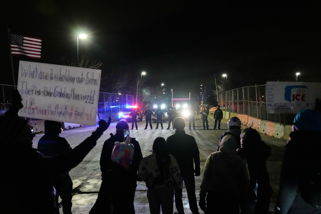 FILE - Federal immigration officers confront protesters outside Bishop Henry Whipple Federal Building in Minneapolis, on Thursday, Jan. 15, 2026. (AP Photo/Yuki Iwamura, File)