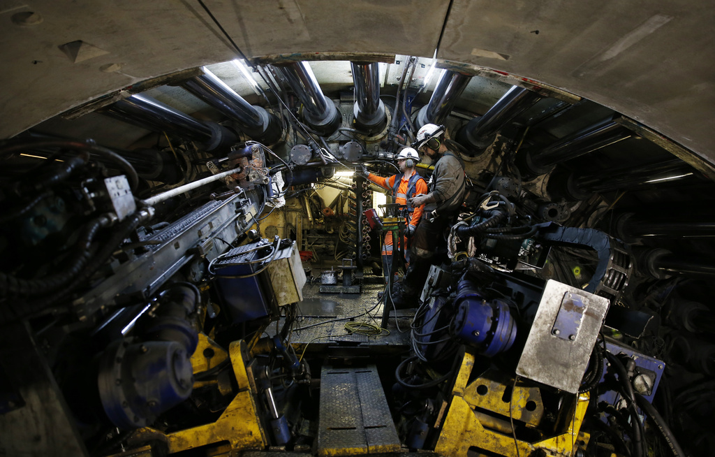 FILE- Engineers operate a 140-meter-long rock-eating machine dubbed 'Federica' in a Turin-Lyon high-speed rail tunnel (TAV) in Saint Martin La Porte, France, Feb. 12, 2019. (AP Photo/Antonio Calanni, File)