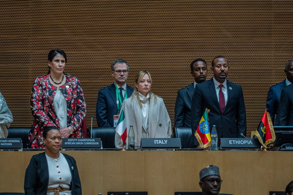Italian Prime Minister Giorgia Meloni, center, stands for the national anthem during the annual African Union Summit at the Addis International Convention Center in Addis Ababa, Ethiopia, Saturday, Feb. 14, 2026. (AP Photo/Amanuel Sileshi)