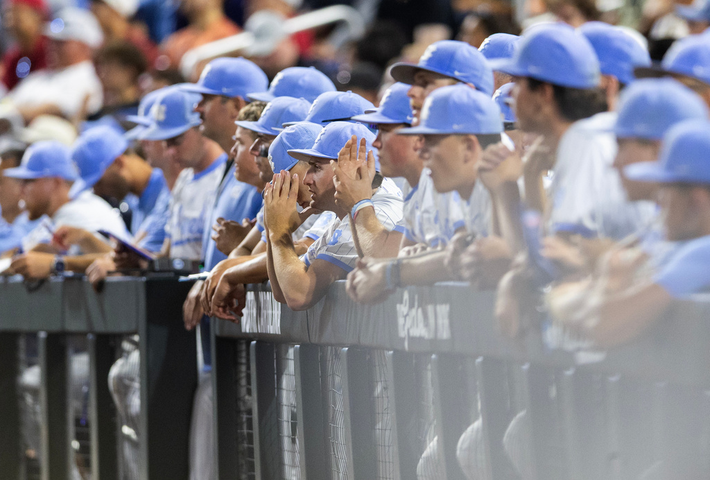 North Carolina players watch from the dugout as Oklahoma goes to bat in the ninth inning of Game 3 of the NCAA College World Series baseball finals in Omaha, Neb., Monday, June 22, 2026. (AP Photo/Rebecca S. Gratz)
