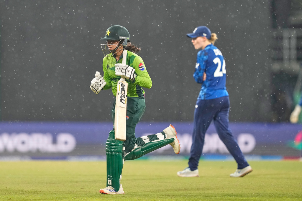 Pakistan's Omaima Sohail runs to pavilion as it rains during the ICC Women's Cricket World Cup match between England and Pakistan at Premadasa Stadium in Colombo, Sri Lanka, Wednesday, Oct, 15, 2025. (AP Photo/Eranga Jayawardena)