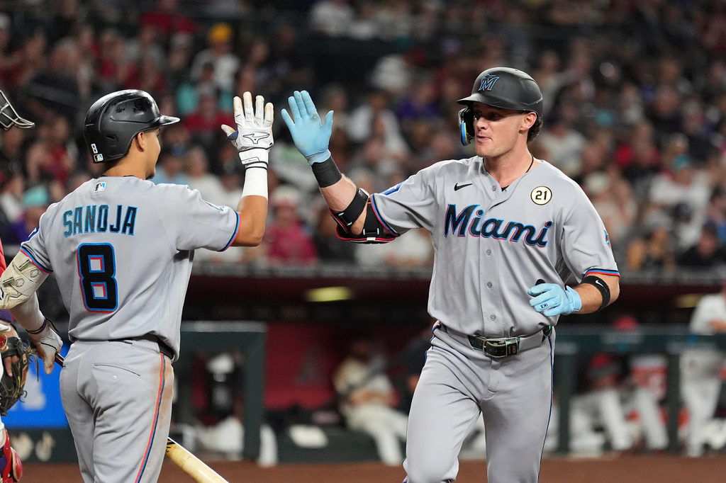 Miami Marlins' Griffin Conine, right, celebrates his home run against the Arizona Diamondbacks with Marlins' Javier Sanoja (8) during the fourth inning of a baseball game, Tuesday, Sept. 15, 2026, in Phoenix. (AP Photo/Ross D. Franklin)