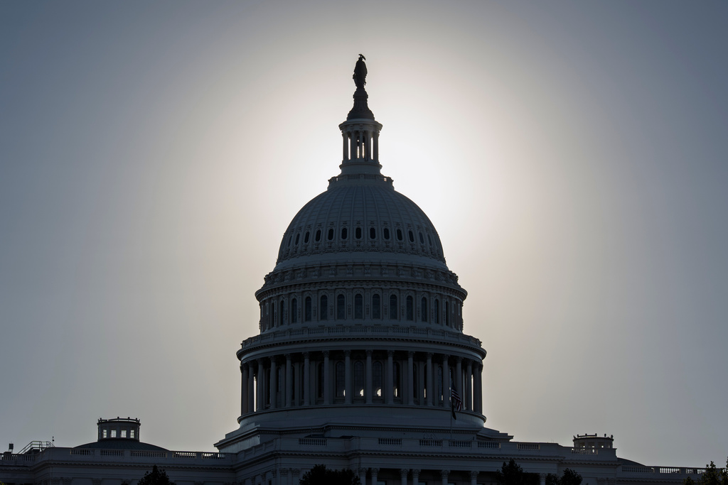 The Capitol is silhouetted by the stark glare of the morning sun as a government shutdown begins its tenth day, in Washington, Friday, Oct. 10, 2025. (AP Photo/J. Scott Applewhite)