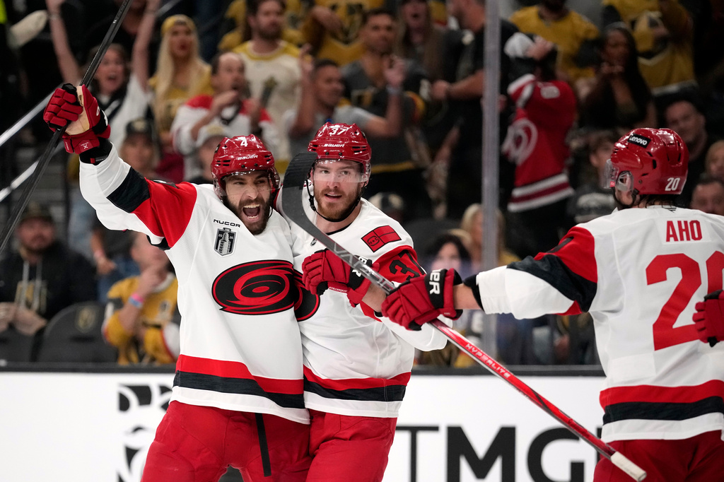 Carolina Hurricanes right wing Andrei Svechnikov, center, celebrates his goal with defenseman Shayne Gostisbehere, left, and center Sebastian Aho during the third period in Game 3 of the NHL hockey Stanley Cup Final series against the Vegas Golden Knights, Saturday, June 6, 2026, in Las Vegas. (AP Photo/John Locher)