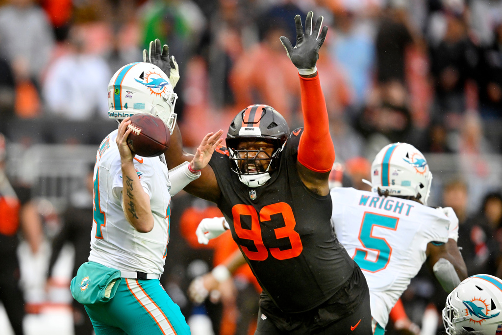 Cleveland Browns defensive tackle Shelby Harris (93) rushes Miami Dolphins quarterback Quinn Ewers (14) in the second half of an NFL football game in Cleveland, Sunday, Oct. 19, 2025. (AP Photo/David Richard)