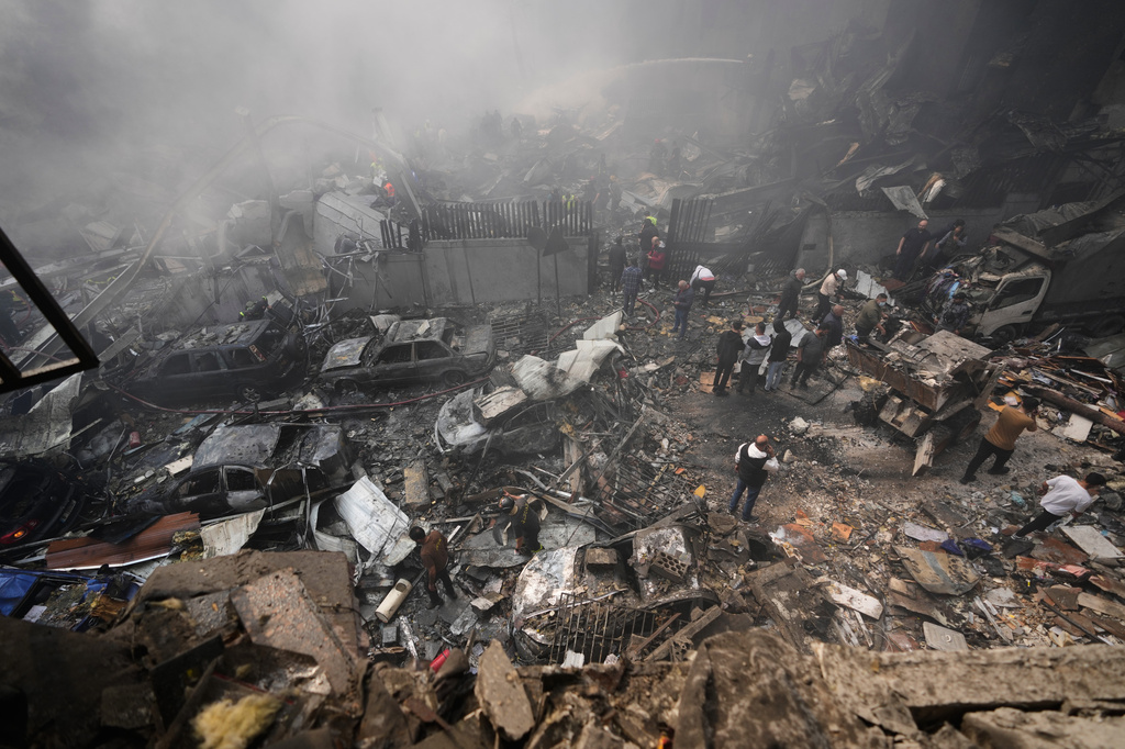 Residents gather at the site of an Israeli airstrike in Beirut, Lebanon, Wednesday, April 8, 2026. (AP Photo/Hussein Malla)