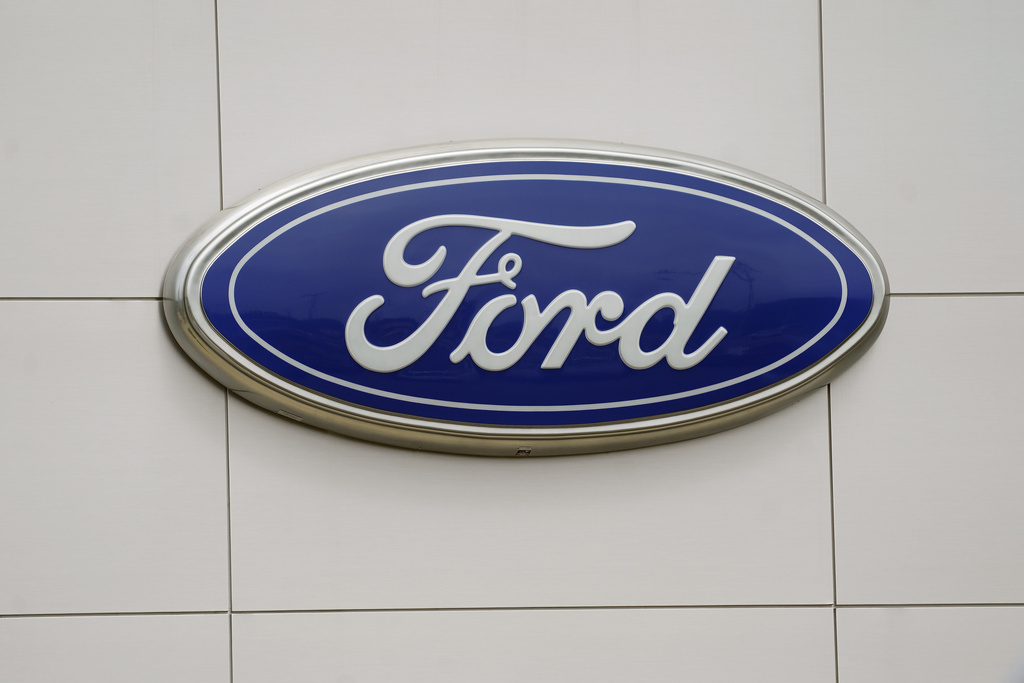 FILE - In this July 27, 2021 file photo, a view of a Ford logo on signage at Country Ford in Graham, N.C. (AP Photo/Gerry Broome, File)