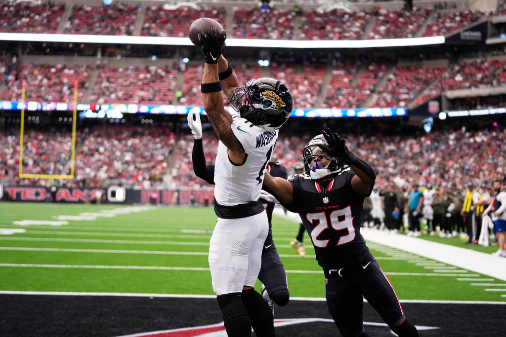 Jacksonville Jaguars wide receiver Parker Washington (11) scores a touchdown against Houston Texans safety M.J. Stewart (29) during an NFL football game, Sunday, Nov. 9, 2025, in Houston. (AP Photo/Eric Christian Smith)