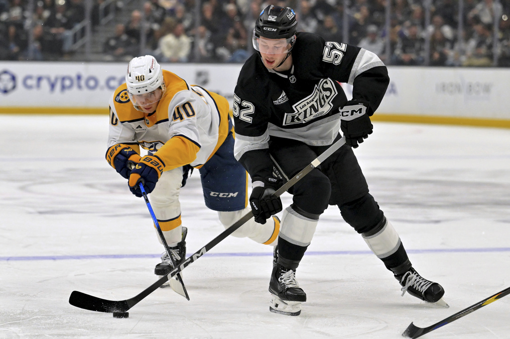 Los Angeles Kings right wing Taylor Ward (52) handles the puck away from Nashville Predators center Fedor Svechkov (40) during the second period of an NHL hockey game Thursday, April 2, 2026, in Los Angeles. (AP Photo/Jayne Kamin-Oncea)