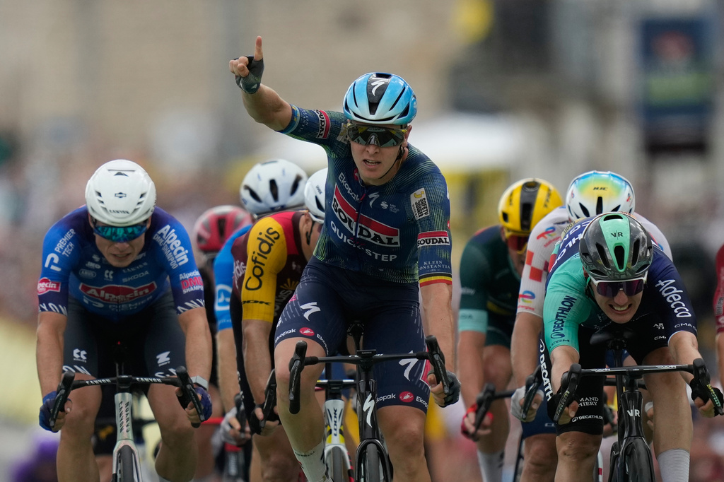 Belgium's Tim Merlier celebrates as he crosses the finish line to win the twelfth stage of the Tour de France cycling race with start in Circuit Nevers Magny-Cours and finish in Chalon-sur-Saone, France, Thursday, July 16, 2026. (AP Photo/Mosa'ab Elshamy)