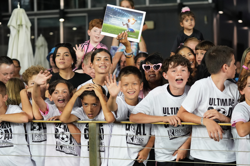 Fans cheer while Inter Miami's Lionel Messi warms up before an MLS soccer match against Atlanta United, Saturday, Oct. 11, 2025, in Fort Lauderdale, Fla. (AP Photo/Lynne Sladky)
