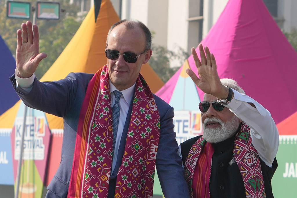 German Chancellor Friedrich Merz, left, and Indian Prime Minister Narendra Modi waves as they arrive for the inauguration of the International Kite Festival in Ahmedabad, India, Monday, Jan. 12, 2026. (AP Photo/Ajit Solanki)