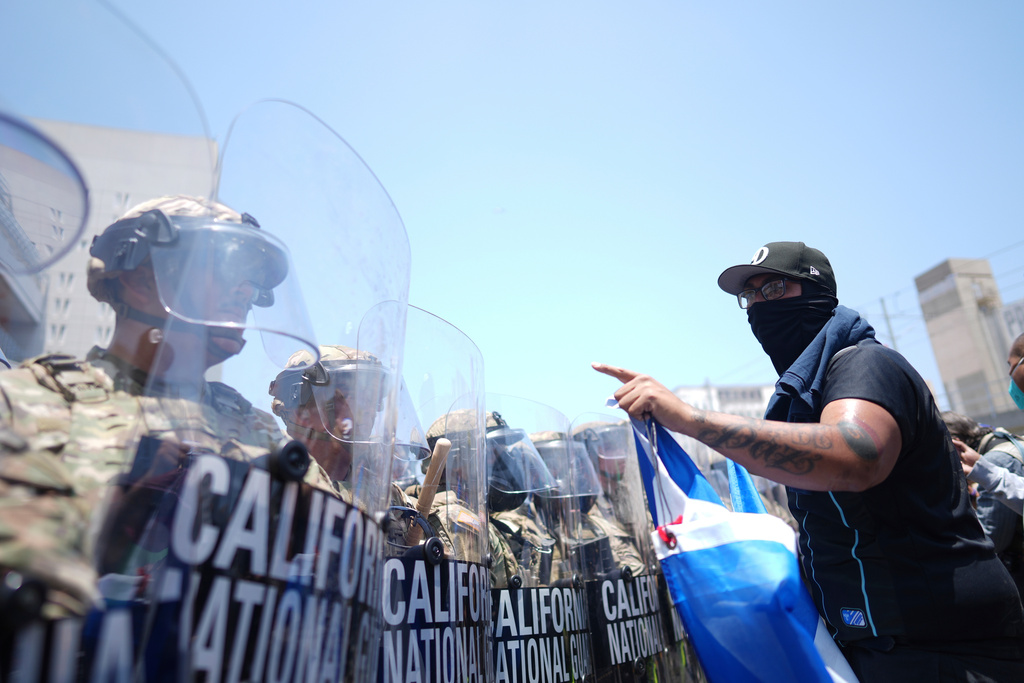 FILE - A protester confronts a line of U.S. National Guard in the metropolitan detention center of downtown Los Angeles, June 8, 2025, following last night's immigration raid protest. (AP Photo/Eric Thayer, File)