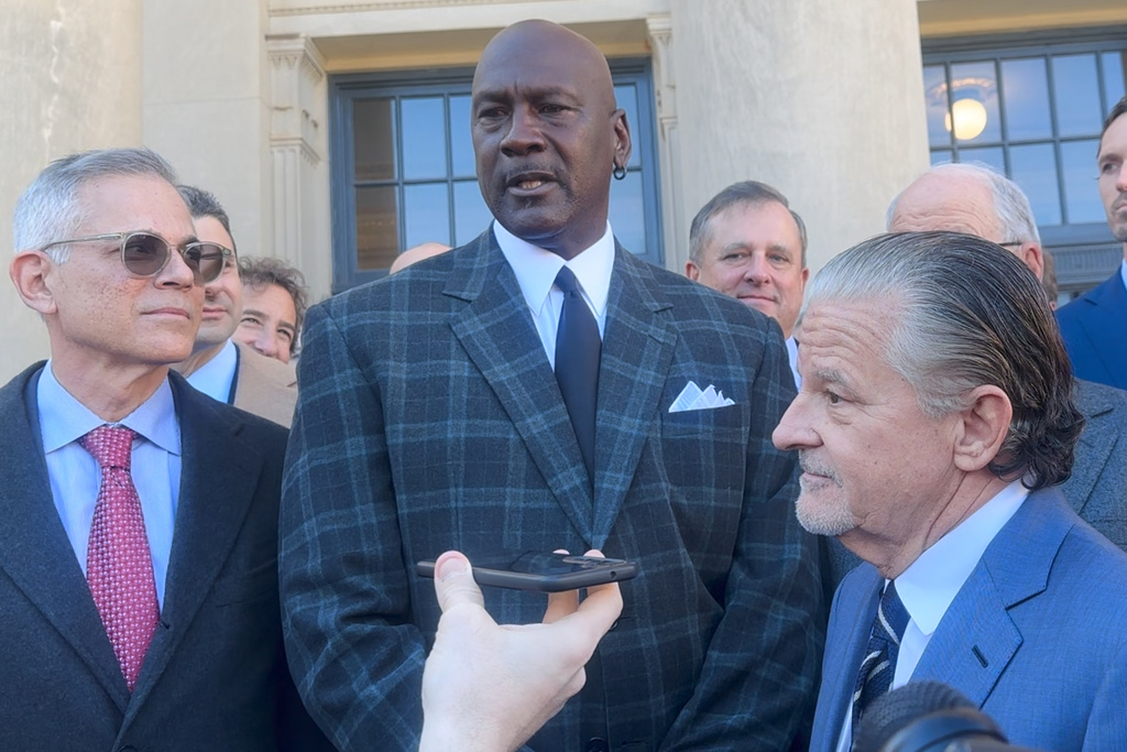 In this image taken from video, Michael Jordan, center, speaks, Thursday, Dec. 11, 2025, outside the federal courthouse in Charlotte, N.C., after NASCAR settled an antitrust lawsuit with two auto racing teams, including one co-owned by Jordan (AP Photo/Jenna Fryer)