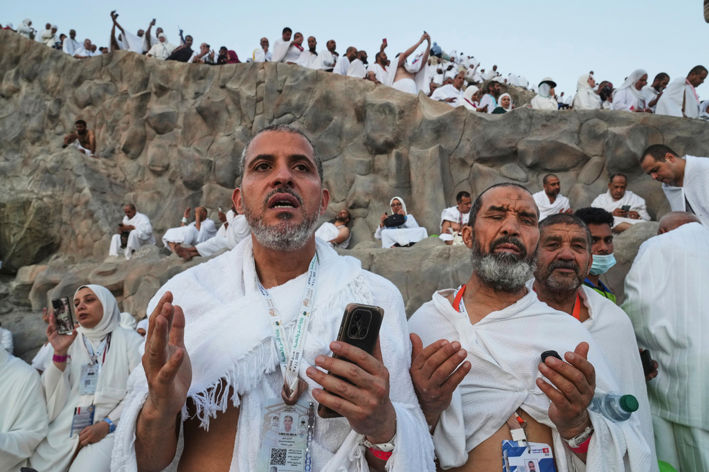 FILE - Muslim pilgrims offer prayers on the Mountain of Mercy, on the Plain of Arafat, during the annual Hajj pilgrimage near the holy city of Mecca, Saudi Arabia, June 5, 2025. (AP Photo/Amr Nabil, File)