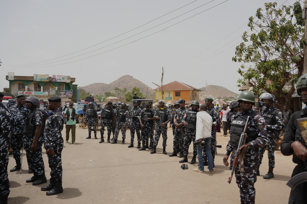 Police officers gather at the scene of Sunday night gunmen attack in Gari Ya Waye community in the Jos North Nigeria, Monday, March 30, 2026. (AP Photo/Samson Omale)