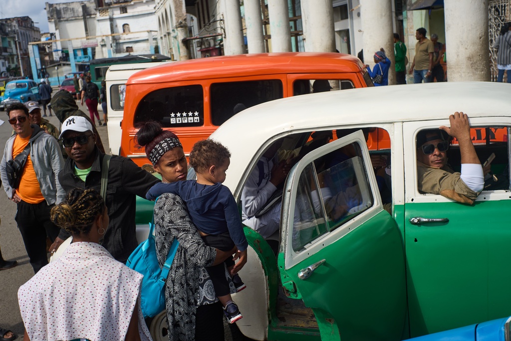 People wait their turns to board shared taxis in Havana, Cuba, Friday, Feb. 6, 2026. (AP Photo/Ramon Espinosa)