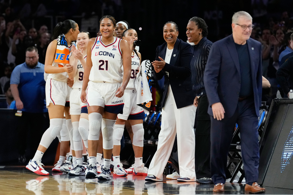 UConn forward Sarah Strong and teammates react at the end of a game against the Notre Dame in the Elite Eight of the NCAA college basketball tournament, Sunday, March 29, 2026, in Fort Worth, Texas. (AP Photo/Tony Gutierrez)