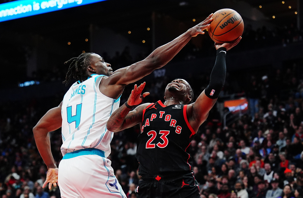 Charlotte Hornets' Sion James (4) strips the ball from Toronto Raptors' Jamal Shead (23) during second half NBA basketball action in Toronto on Friday, Dec. 5, 2025. (Frank Gunn/The Canadian Press via AP)