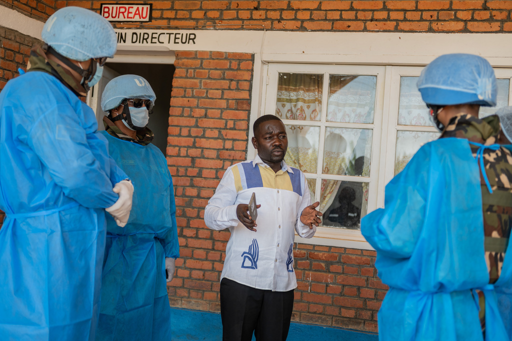 Richard Lokudu, center, the medical director of Mongbwalu General Hospital, speaks with UN peacekeepers in Mongbwalu, Congo, Friday, June 5, 2026. (AP Photo/Moses Sawasawa)