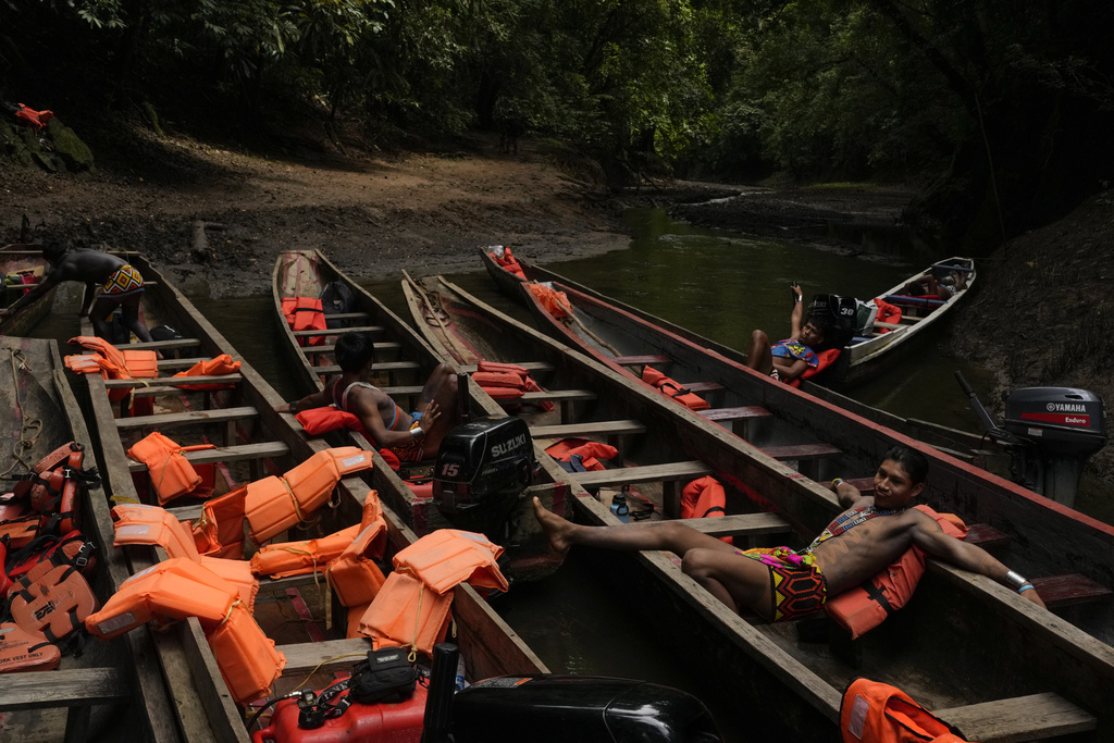 Embera Indigenous guides wait for the return of visitors touring the Chagres River, once the main colonial waterway carrying goods across Panama, between the Pacific Ocean and Caribbean, Saturday, Aug. 16, 2025. (AP Photo/Matias Delacroix)