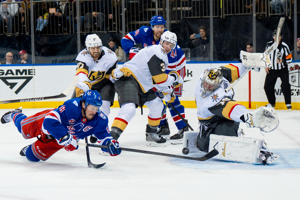 New York Rangers center J.T. Miller (8) falls while attempting a goal during the second period of an NHL hockey game against the Vegas Golden Knights, Sunday, Dec. 7, 2025, in New York. (AP Photo/Angelina Katsanis)
