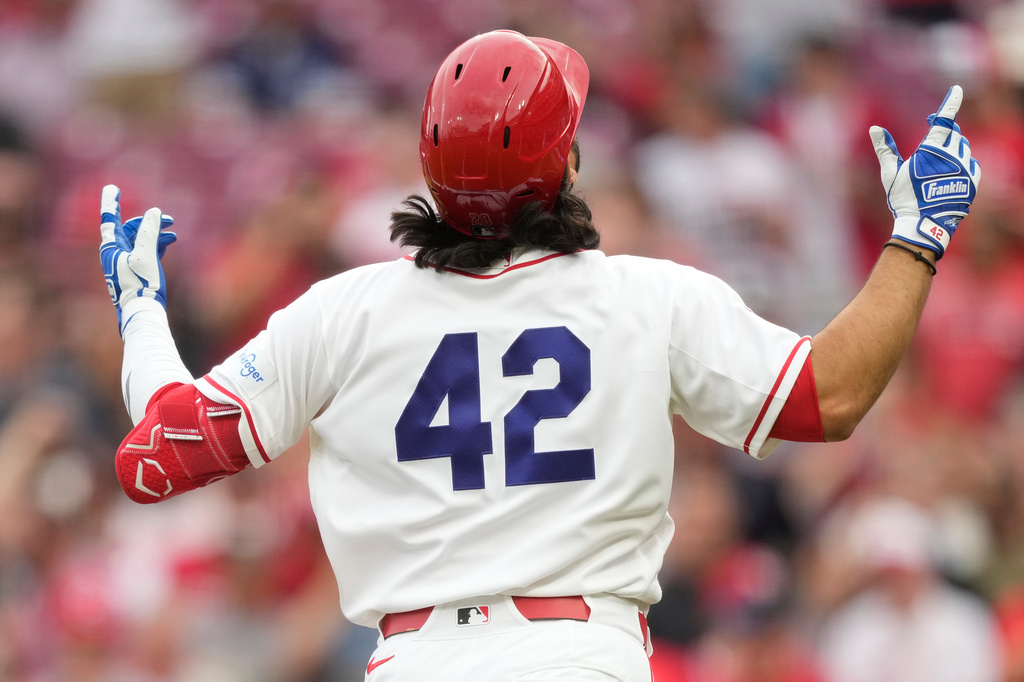 Cincinnati Reds' Eugenio Suárez, wearing No. 42 to commemorate Jackie Robinson Day, reacts as he rounds the bases after hitting a solo home run during the first inning of a baseball game against the San Francisco Giants in Cincinnati, Wednesday, April 15, 2026. (AP Photo/Carolyn Kaster)