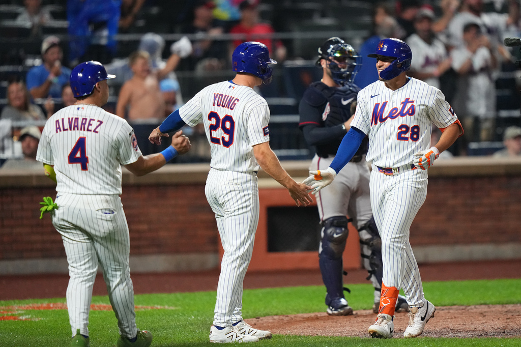 New York Mets' Tyrone Taylor (28) celebrates with teammates Jared Young (29) and Francisco Alvarez (4) after hitting a three-run home run during the seventh inning of a baseball game against the Atlanta Braves Monday, July 27, 2026, in New York. (AP Photo/Frank Franklin II)