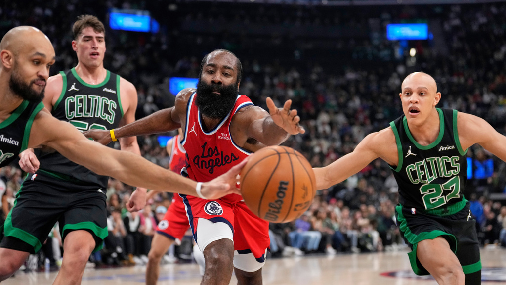Boston Celtics forward Josh Minott, left, guard Jordan Walsh, right and Los Angeles Clippers guard James Harden, second from left, reach for a loose ball during the first half of an NBA basketball game Saturday, Jan. 3, 2026, in Inglewood, Calif. (AP Photo/Mark J. Terrill)