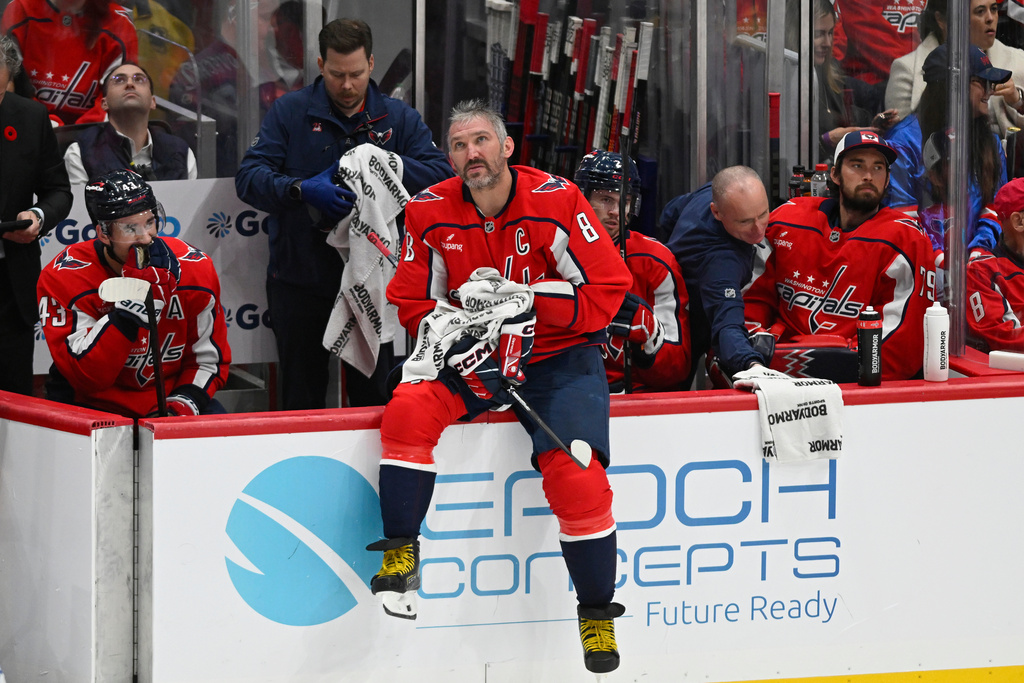 Washington Capitals left wing Alex Ovechkin (8) sits on the sidelines during timeout after scoring his 900th career NHL goal during the second period of an NHL hockey game against the St. Louis Blues, Wednesday, Nov. 5, 2025, in Washington. (AP Photo/John McDonnell)