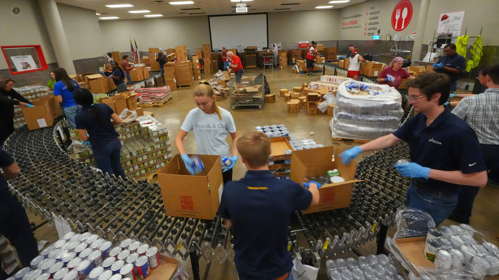 FILE - Volunteers prepare emergency food packages at the Tarrant Area Food Bank in Fort Worth, Texas, Oct. 28, 2025. (AP Photo/LM Otero, File)