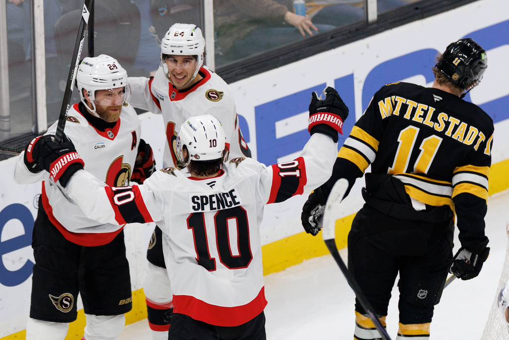 Ottawa Senators' Claude Giroux (28) celebrates after his goal with teammates Dylan Cozens (24) and Jordan Spence (10) during the first period of an NHL hockey game against the Boston Bruins in Boston, Sunday, Dec. 21, 2025. (AP Photo/CJ Gunther)