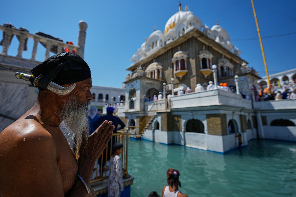 A Sikh pilgrim prays as he attends a ceremony to celebrate Vaisakhi festival, which also marks the New Year in Sikh tradition, at the shrine of Gurdwara Punja Sahib, the second most sacred place for Sikhs, in Hassan Abdal, Pakistan, Tuesday, April 14, 2026. (AP Photo/Anjum Naveed)