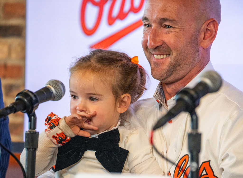 Baltimore Orioles new manager Craig Albernaz holds his two-year-old daughter Gigi as he takes questions from reporters during a news conference, Tuesday, Nov. 4, 2025, in Baltimore. (Jerry Jackson/The Baltimore Banner via AP)