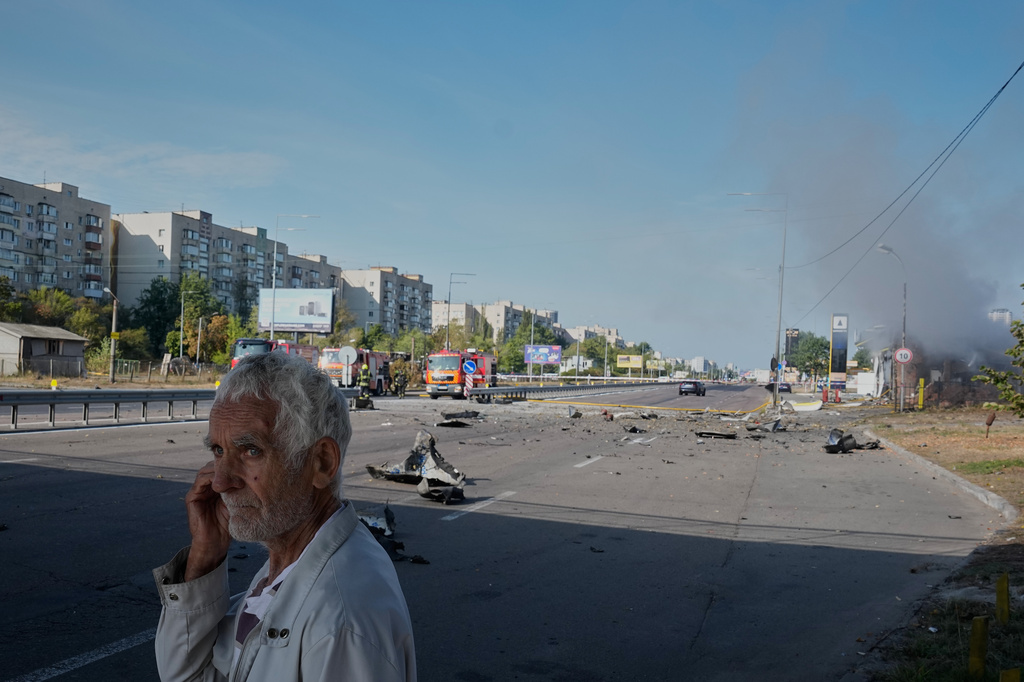 A civilian walks by after a gas station was hit by a Russian drone in Kyiv, Ukraine, Friday, Sept. 11, 2026. (AP Photo/Efrem Lukatsky)