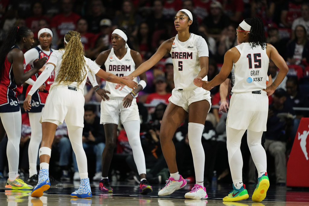 Atlanta Dream forward Angel Reese (5) celebrates with teammates after being fouled against during the first half in Game 2 of a WNBA basketball first-round playoff series against the Washington Mystics, Wednesday, Sept. 30, 2026, in Washington. (AP Photo/Stephanie Scarbrough)