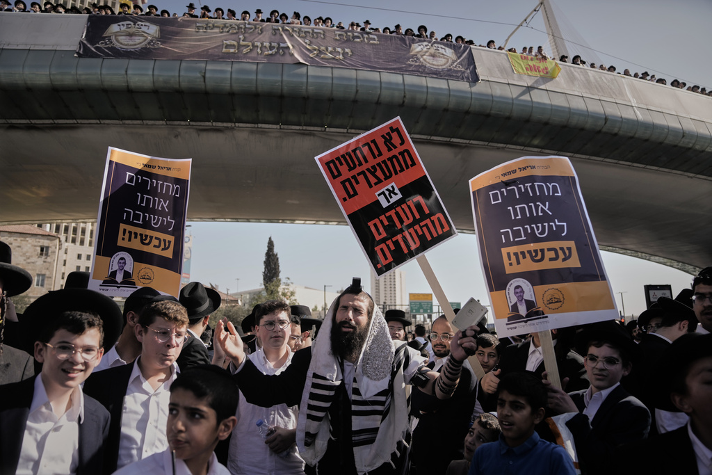 Ultra-Orthodox Jews rally in a massive show against plans to force them to serve in the Israeli military, in Jerusalem, Thursday, Oct. 30, 2025. (AP Photo/Mahmoud Illean)