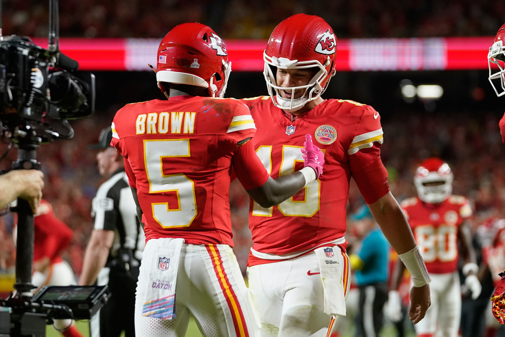 Kansas City Chiefs wide receiver Hollywood Brown (5) is congratulated by quarterback Patrick Mahomes (15) after scoring during the second half of an NFL football game against the Detroit Lions Sunday, Oct. 12, 2025, in Kansas City, Mo. (AP Photo/Ed Zurga)