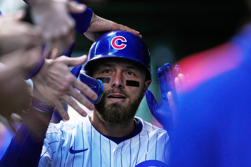 Chicago Cubs' Michael Busch celebrates after hitting a home run during the first inning of Game 3 of baseball's National League Division Series against the Milwaukee Brewers Wednesday, Oct. 8, 2025, in Chicago. (AP Photo/Erin Hooley)