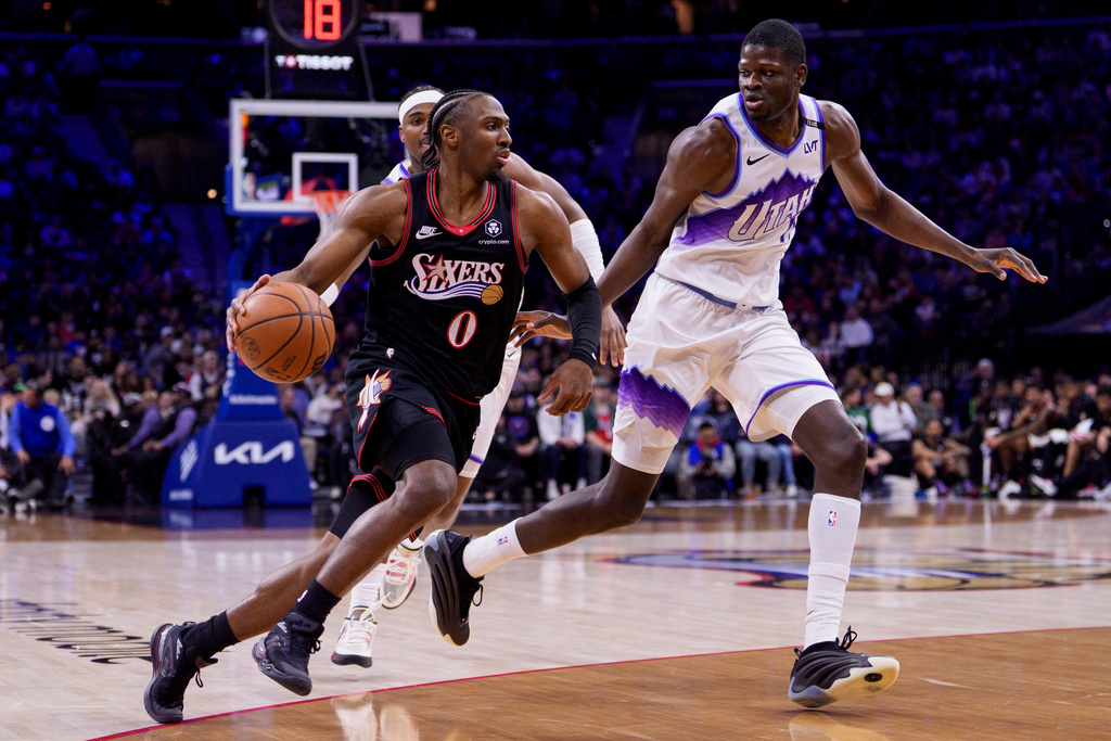 Philadelphia 76ers' Tyrese Maxey, left, drives to the basket against Utah Jazz's Mo Bamba, right, during the first half of an NBA basketball game, Wednesday, March 4, 2026, in Philadelphia. (AP Photo/Chris Szagola)