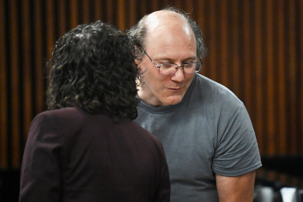 Lorenz Kraus, a 53-year-old man who was arrested for murder after telling a television news anchor that he killed his parents, speaks to Albany County Assistant Public Defender Rebekah Sokol during Kraus' arraignment on Friday, Sept. 26, 2025, at Albany City Court in Albany, N.Y. (Will Waldron/The Albany Times Union via AP)