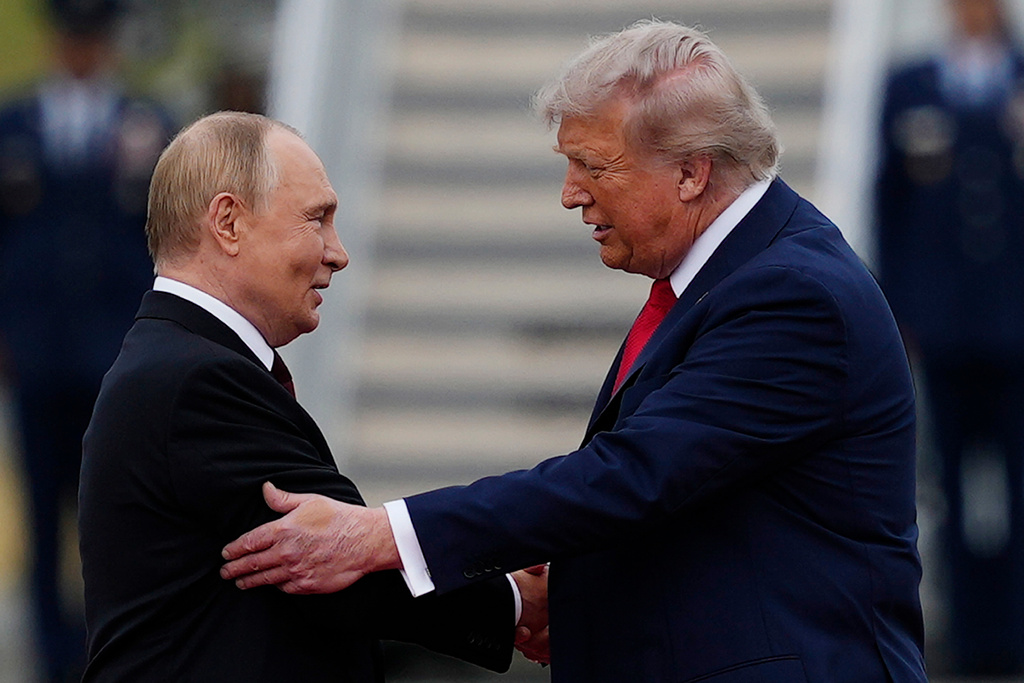 FILE - U.S. President Donald Trump greets Russian President Vladimir Putin, Aug. 15, 2025, at Joint Base Elmendorf-Richardson, Alaska. (AP Photo/Julia Demaree Nikhinson, File)