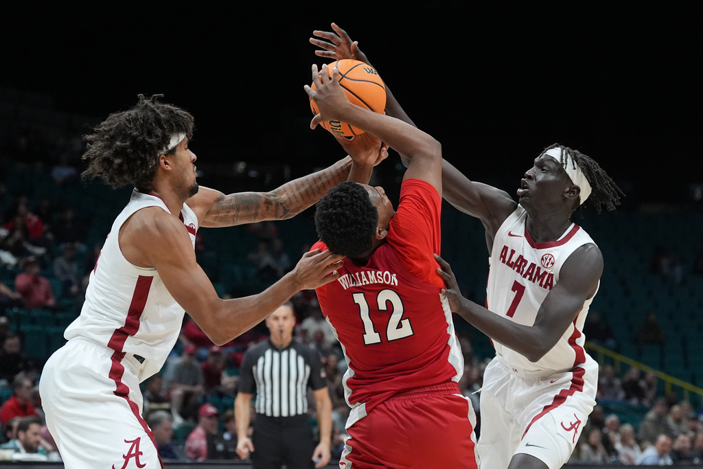 UNLV guard Issac Williamson (12) is pressured by Alabama forward Amari Allen, left, and Alabama forward Taylor Bol Bowen (7) during the second half of an NCAA college basketball game in the Players Era tournament Las Vegas, Tuesday, Nov. 25, 2025. (AP Photo/Eric Gay)