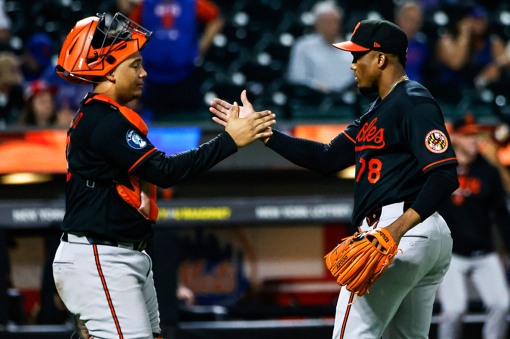 Baltimore Orioles pitcher Yennier Cano (78) celebrates with catcher Samuel Basallo after defeating the New York Mets in a baseball game, Wednesday, Sept. 16, 2026, in New York. (AP Photo/Eduardo Munoz Alvarez)