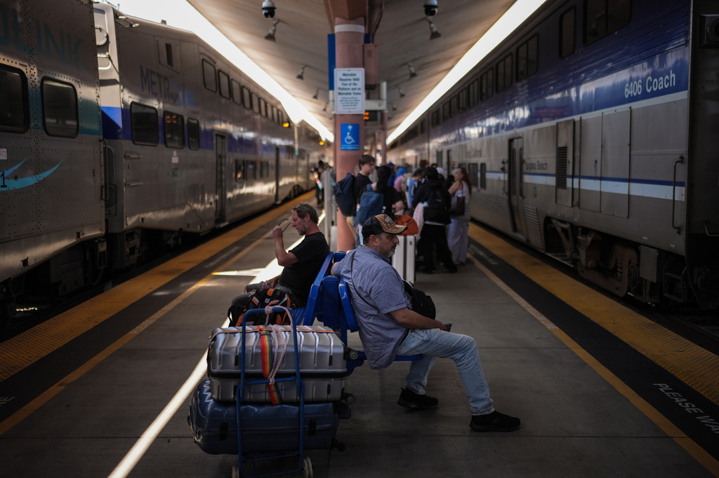 Travelers wait to board an Amtrak train at Union Station in Los Angeles, Wednesday, May 20, 2026. (AP Photo/Jae C. Hong)