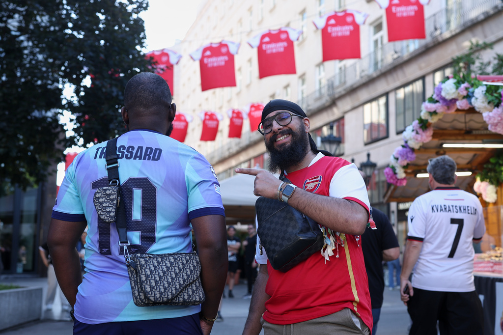 Arsenal supporters pose for a photo the day before the Champions League final soccer match between Paris Saint-Germain and Arsenal in Budapest, Hungary, Friday, May 29, 2026. (AP Photo/Armin Durgut)