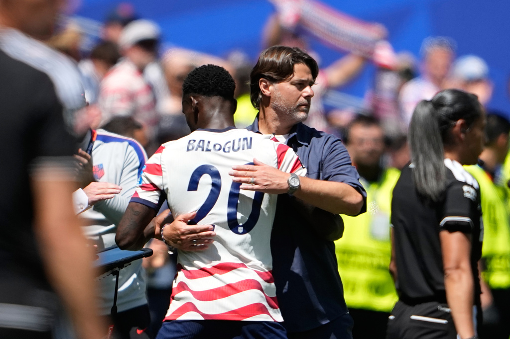 United States head coach Mauricio Pochettino embraces United States' Folarin Balogun after he was substituted during the World Cup Group D soccer match between the United States and Australia in Seattle, Friday, June 19, 2026. (AP Photo/Lindsey Wasson)